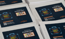 stacks of printed postcards promoting "Your Health Passport" by ArchWell Health, featuring a suitcase graphic with "Health is a Daily Practice" and a QR code for more information.