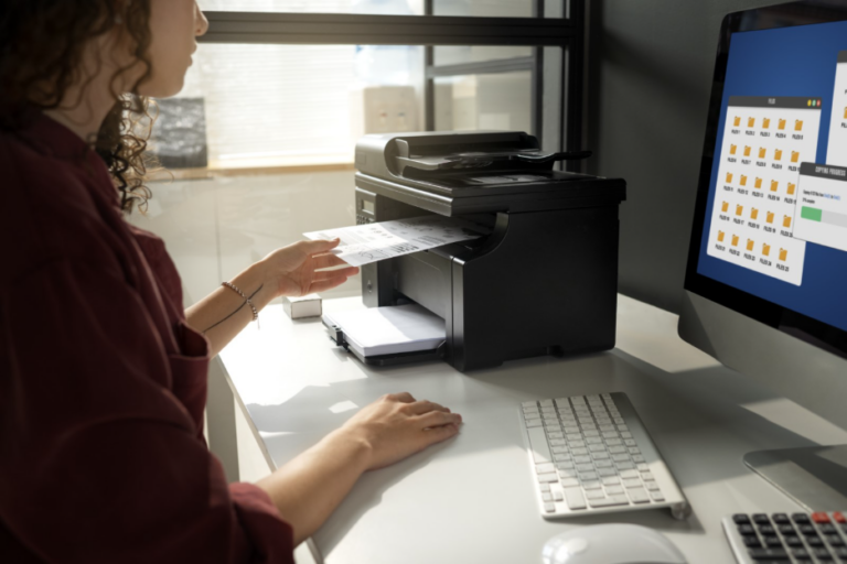 Marketing professional retrieving a personalized direct mail piece from a variable data printing production setup.