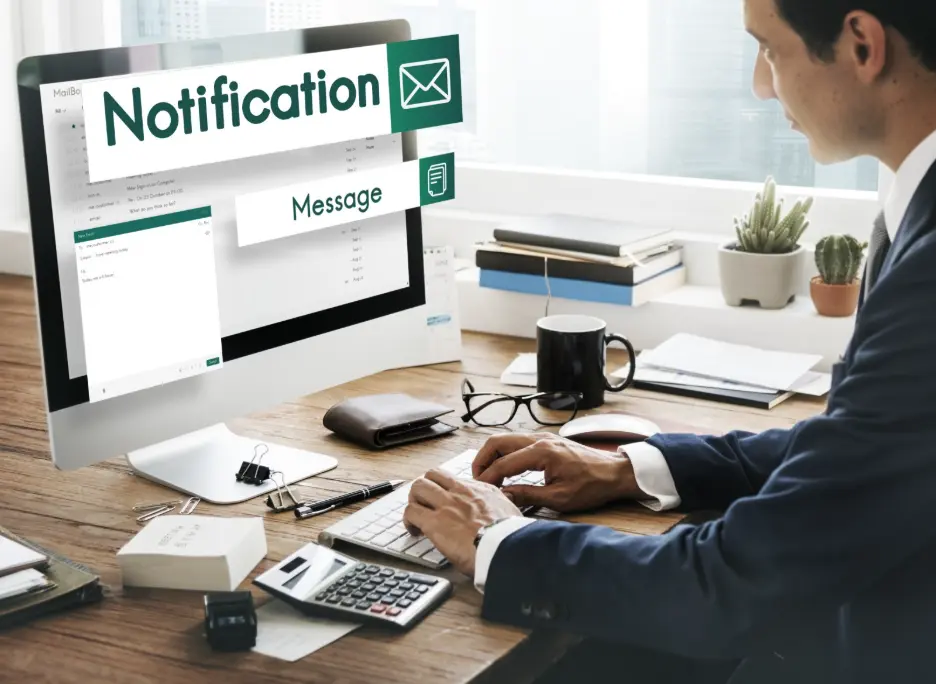 Marketing professional managing automated direct mail campaigns from a desktop workstation.